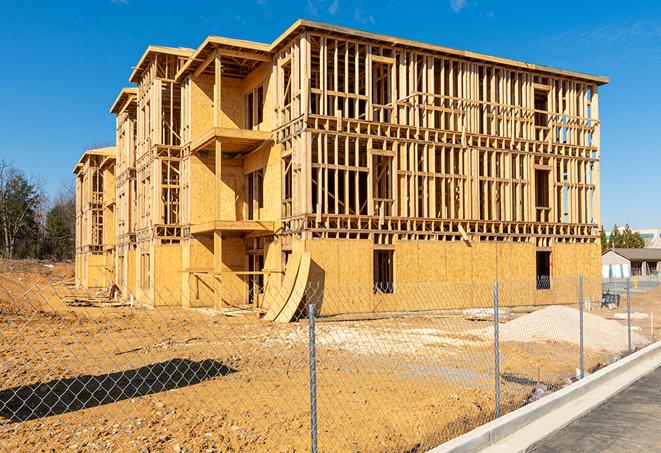 a close-up of temporary chain link fences enclosing a job site, signaling progress in the project's development in Reading, MA